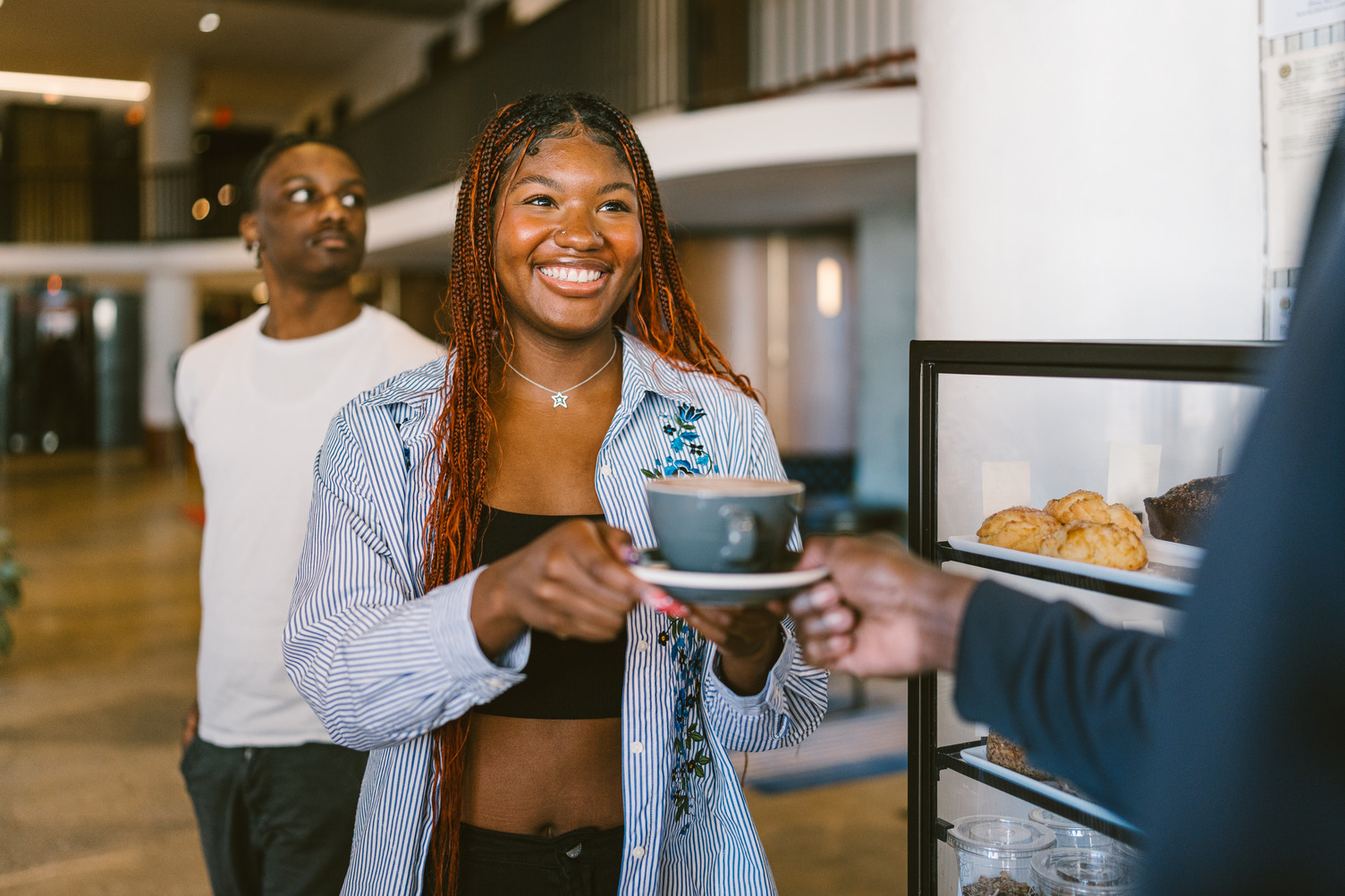 Female worker receiving the latte she ordered