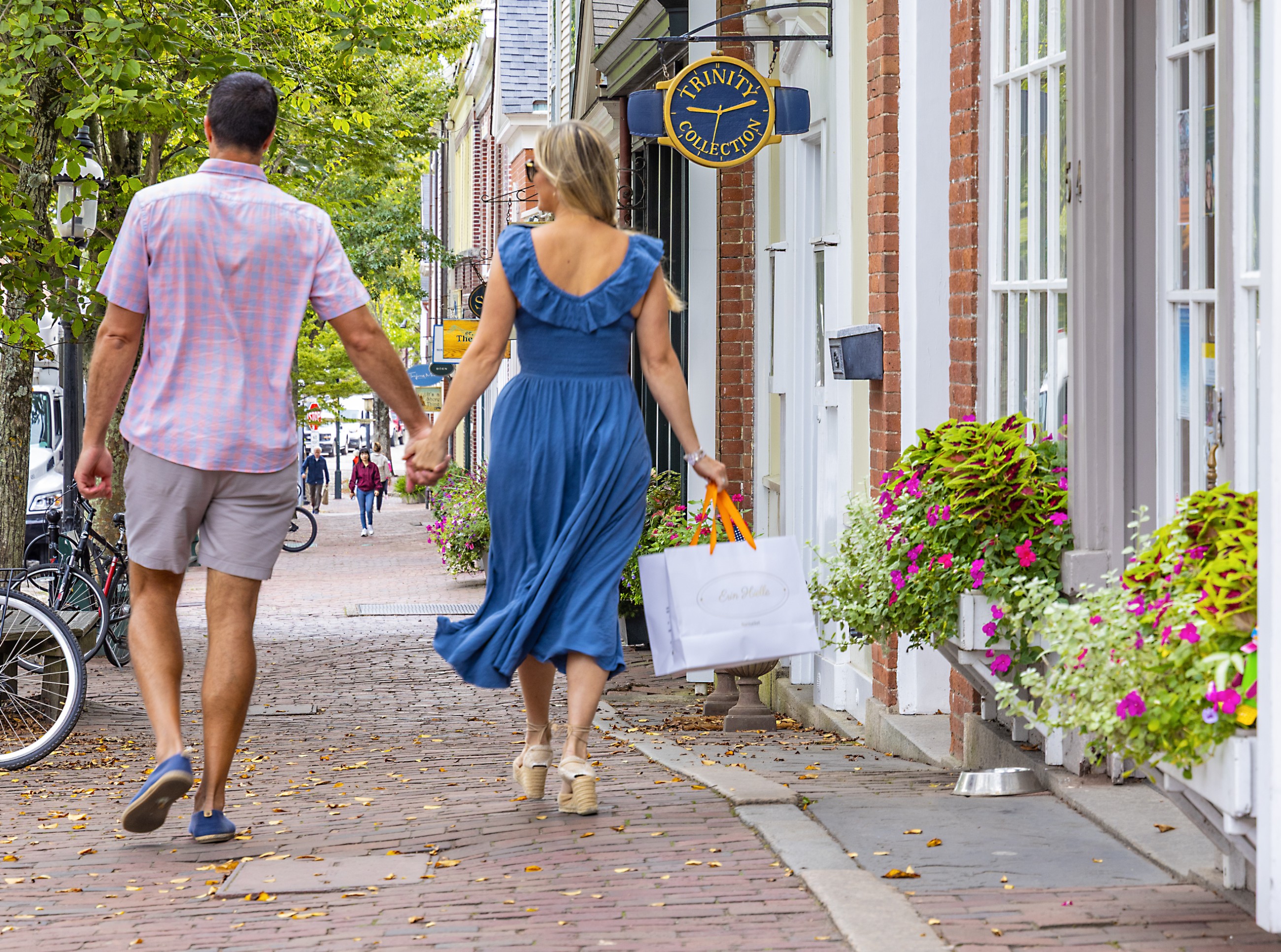 Couple holding hands while walking through downtown Nantucket