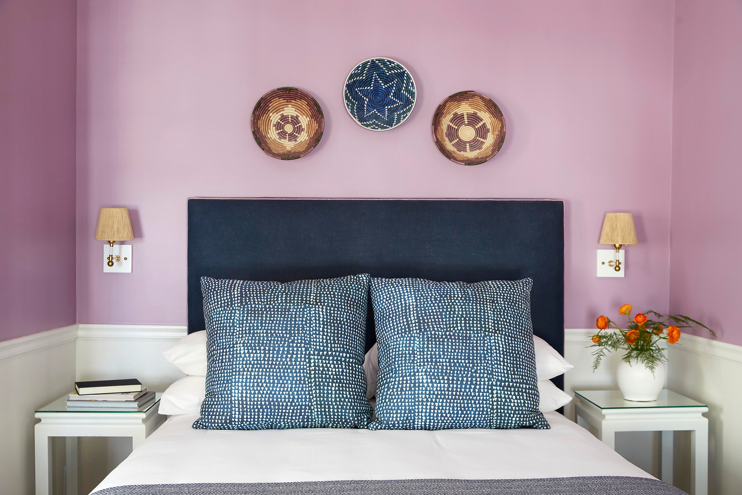 Queen bed with two side tables in a guest room at The Christopher