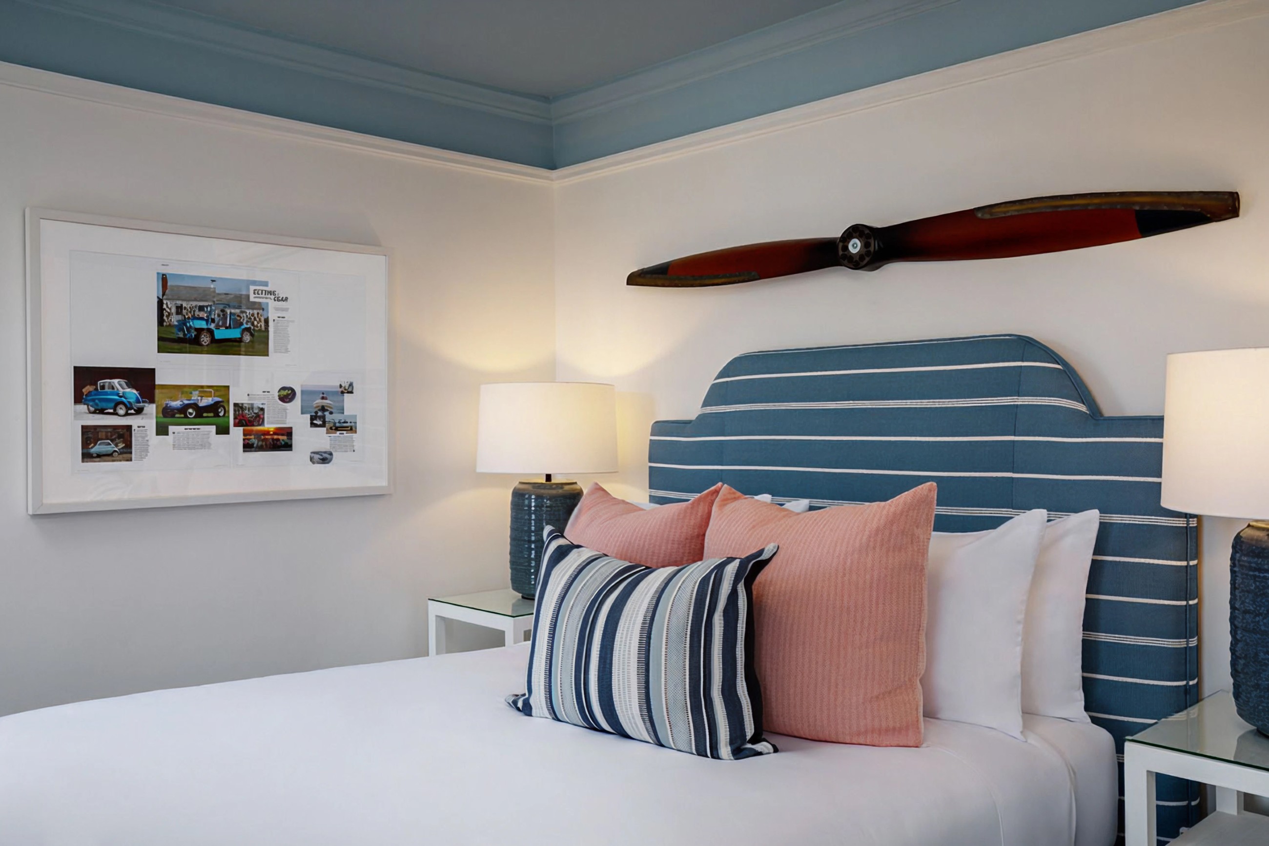 Queen guest room at 76 Main Ink Press Hotel featuring a propeller above the Headboard and art on the wall
