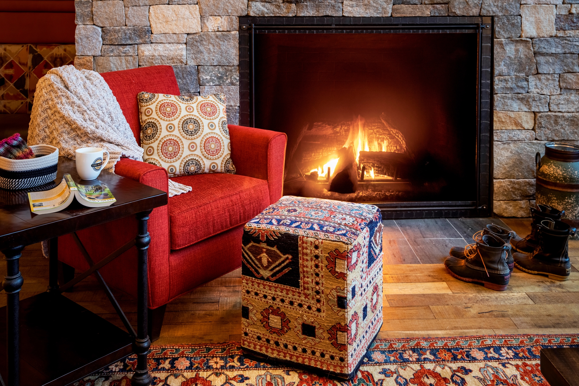 Red chair in front of a fireplace at The Glen House