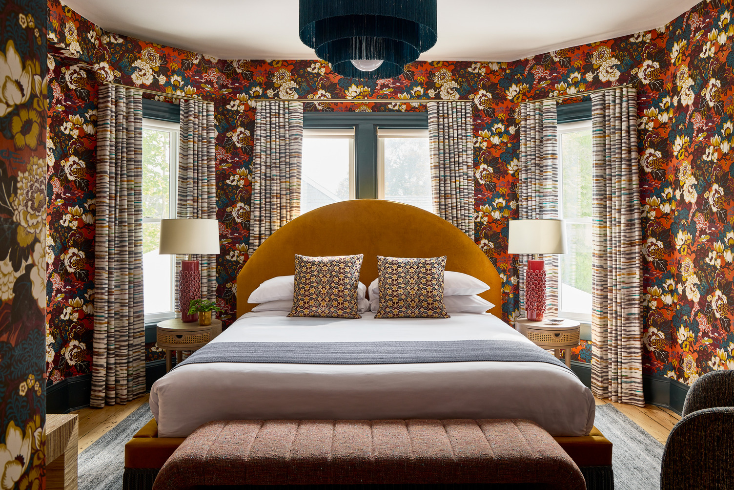 The Peacock King room that features bright flower wallpaper