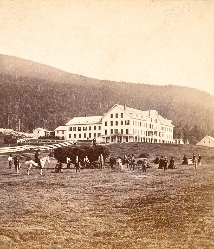 Historic image of Glen with people and horses on the front lawn
