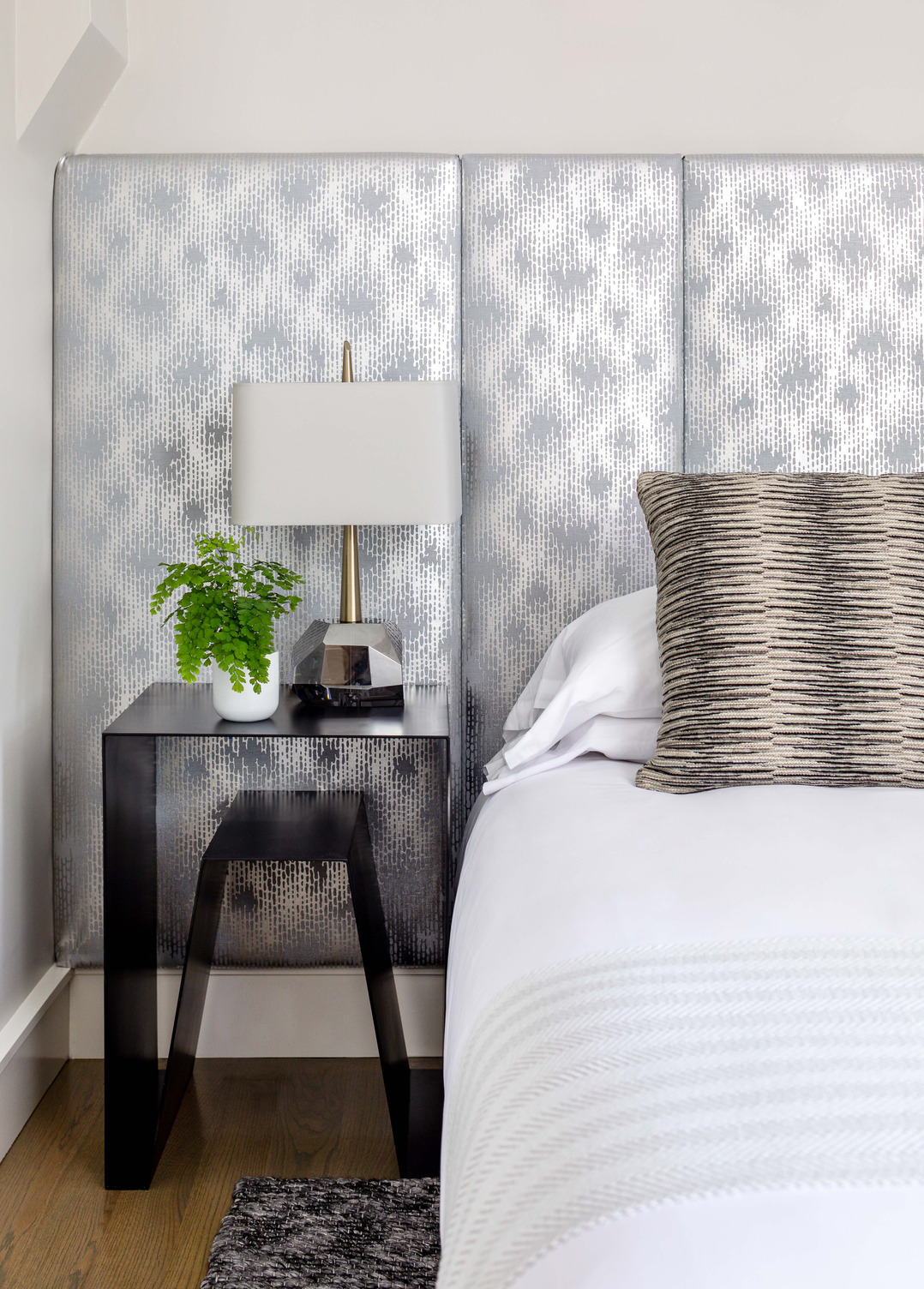 Close up of a side table and silver backsplash in a guest room at The Richard