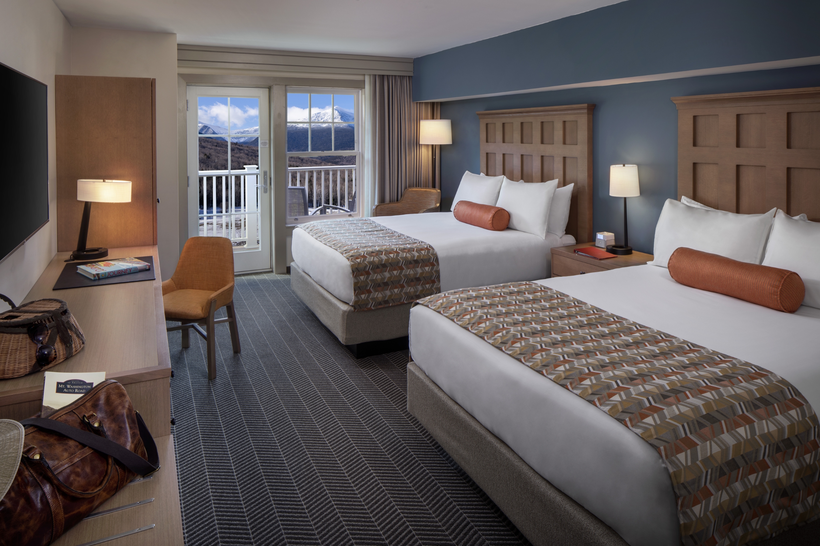 Double queen guest room with a mountain view